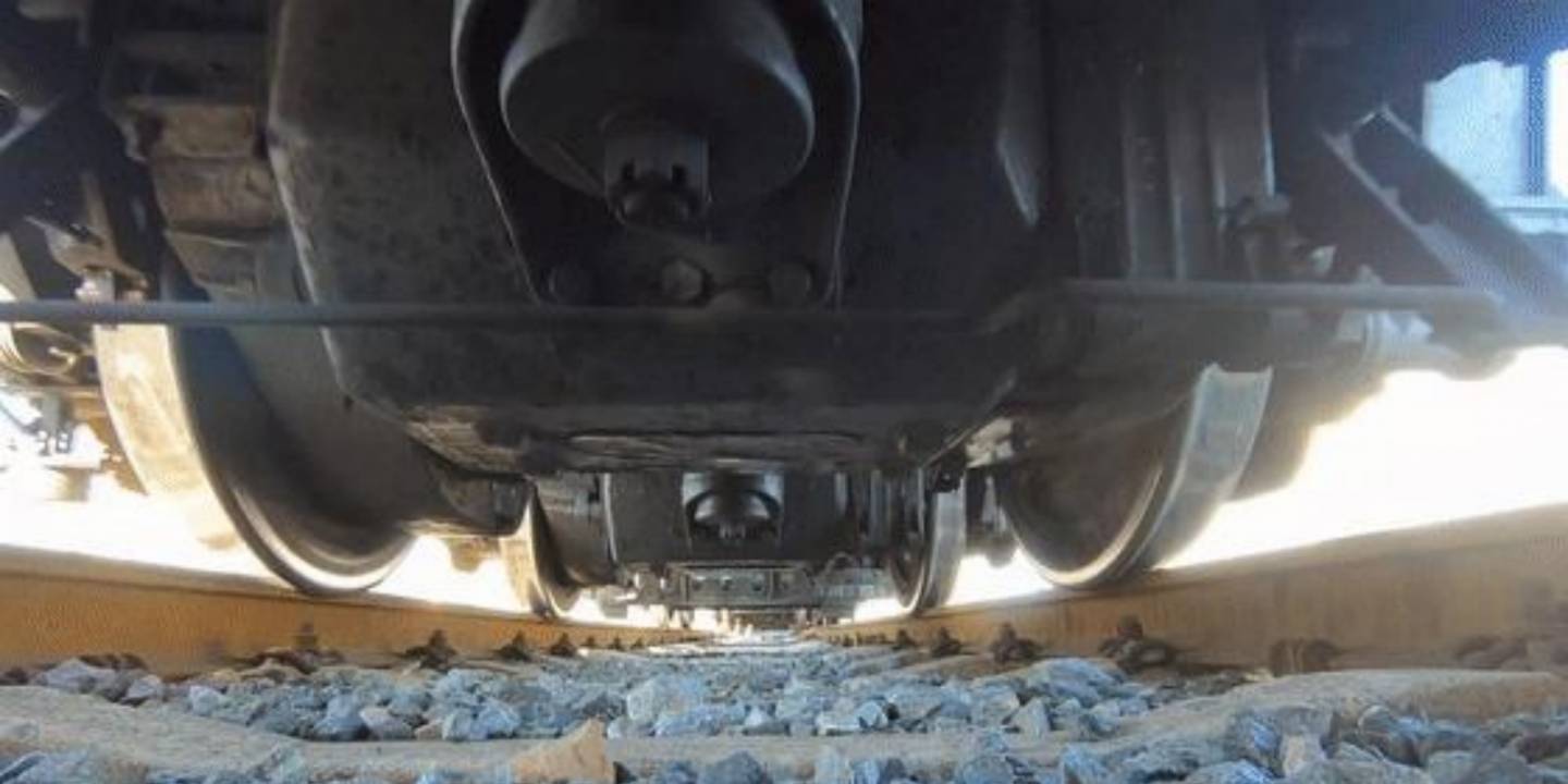 The wheel-rail interface features a precisely engineered conical profile.